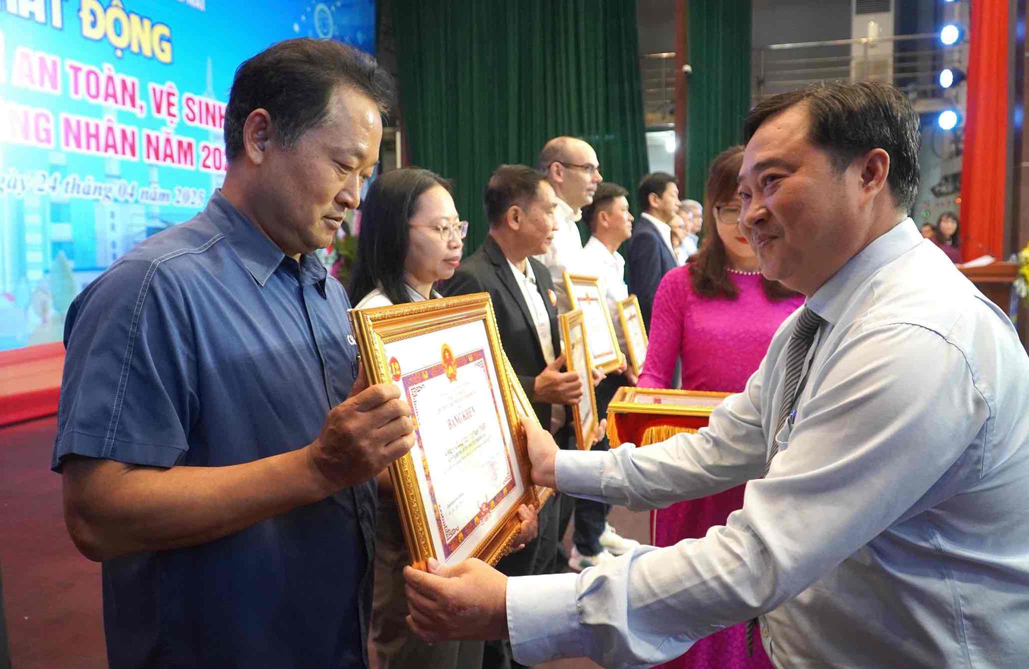 Director of the Department of Home Affairs of Dong Nai province Nguyen Huu Dinh presented a certificate of merit to the representative of the Board of Directors of Chang Shin Vietnam Company Limited for its achievements in ensuring occupational safety and hygiene. Photo: HAC