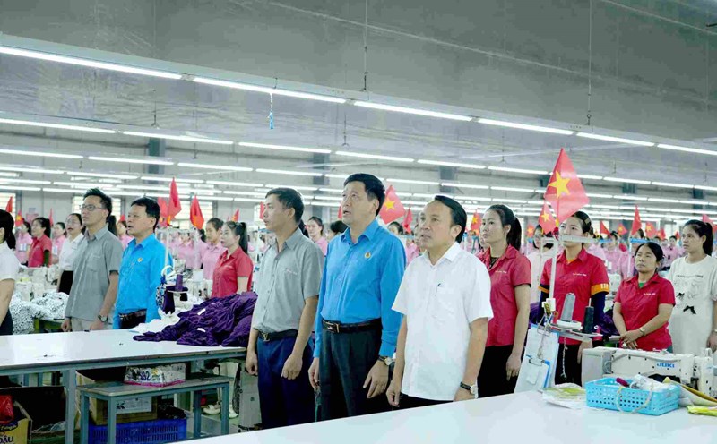 Chairman of Nghe An Provincial Federation of Labor Kha Van Tam and leaders of Nghi Loc district raised the flag and sang the national anthem with workers. Photo: Duy Chuong