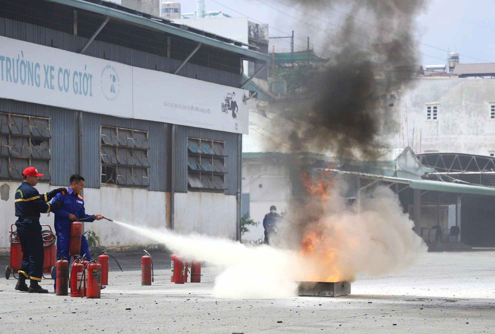 Practicing extinguishing simulated fires caused by gasoline. Photo: Minh Quan