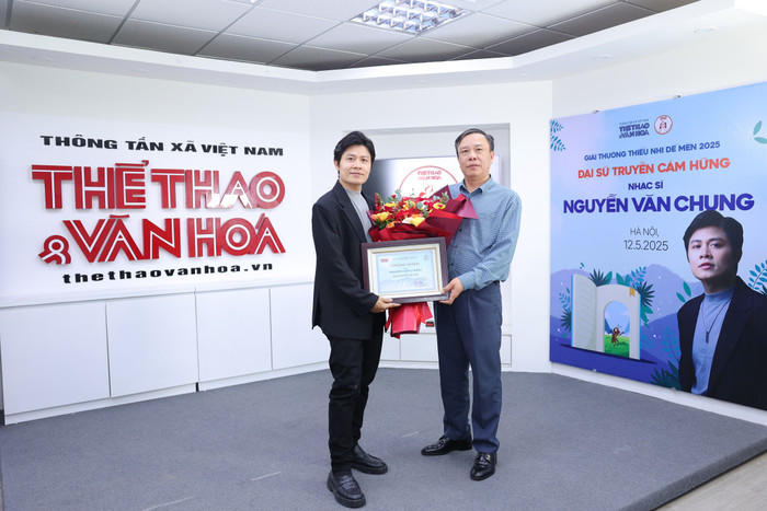 El periodista Nguyen Thien Thuy - Editor General de la Revista Deportiva y Cultural - entrego flores y un Certificado de Embajador Inspirador al musico Nguyen Van Chung. Foto: Diario de Deportes y Cultura