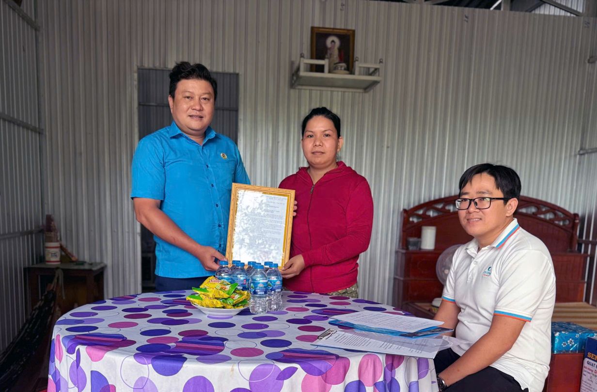 Chu tich Cong doan cac khu cong nghiep, khu kinh te Dong Thap Nguyen Thanh Nhan trao quyet dinh ban giao Mai am Cong doan cho doan vien Phan Thi Ha. Anh: Thanh Nhan