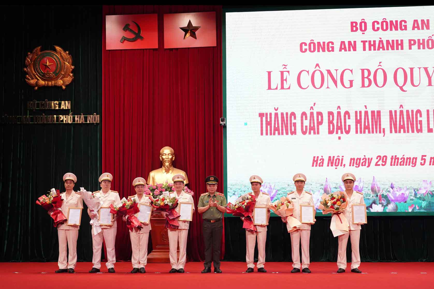 Lieutenant General Nguyen Thanh Tung, Director of Hanoi Police, presented the decision and presented flowers to congratulate the comrades on being promoted to the rank of colonel. Photo: Hanoi Police