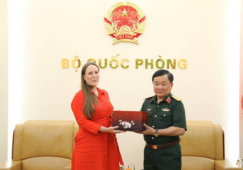 Thượng tướng Hoàng Xuân Chiến - Ủy viên Trung ương Đảng, Ủy viên Thường vụ Quân ủy Trung ương, Thứ trưởng Bộ Quốc phòng - trao quà lưu niệm tặng bà Veerle Nouwens - Giám đốc điều hành Viện Nghiên cứu chiến lược quốc tế (IISS) khu vực châu Á. Ảnh: Bộ Quốc phòng