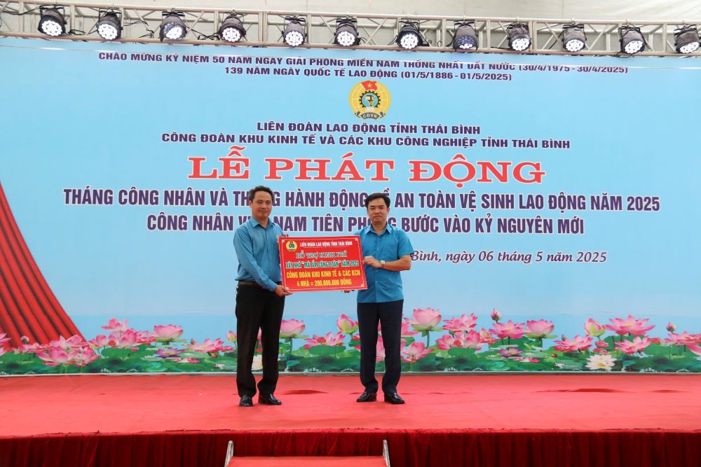 El presidente de la LDP de la provincia de Taiping, Bui Xuan Vinh (derecha), entrego el simbolo de la financiacion para la construccion de viviendas al lider del sindicato provincial KKT&CKCN. Imagen de la ciudad de Ba Man