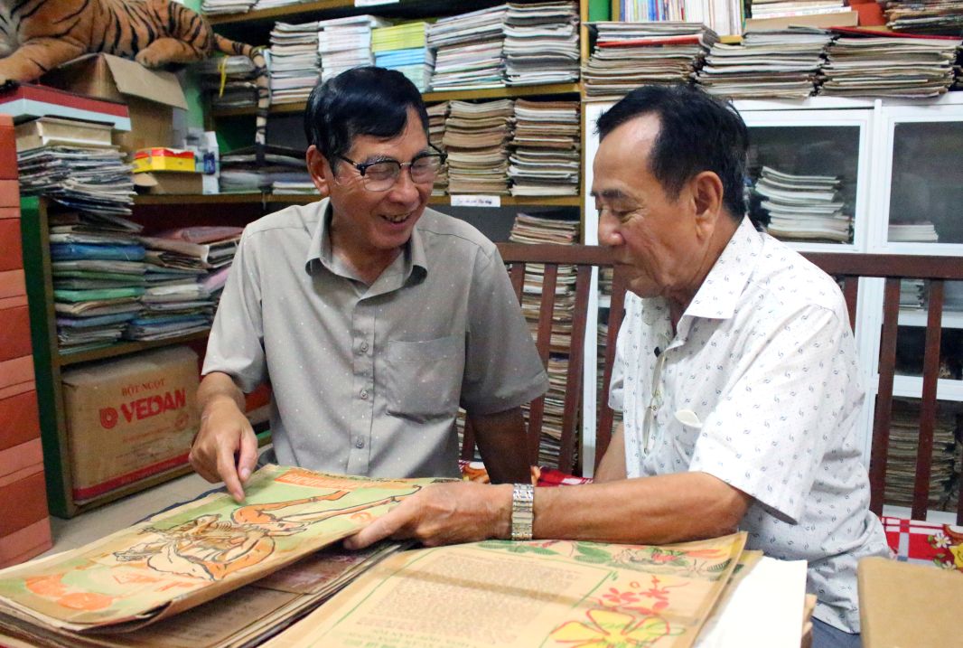 Nha bao Ngo Hoang Van va nha bao Truong Thanh Nha (trai sang) chia se cam xuc khi xem lai nhung vai viet tren bao Chien Thang cach day hon nua the ky. Anh: Luc Tung