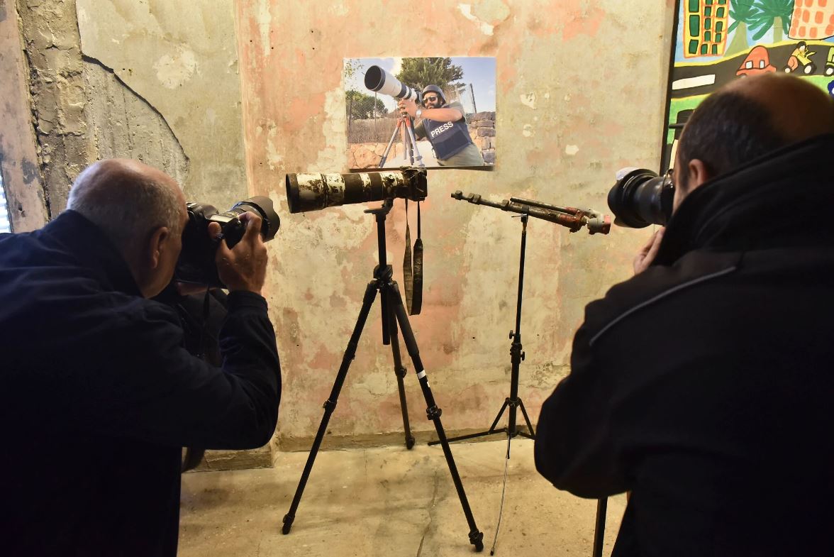 Reporteros capturan la camara dañada del difunto fotografo Issam Abdallah en una conferencia de prensa en Beirut Libano el 7 de diciembre de 2023. Foto: AFP