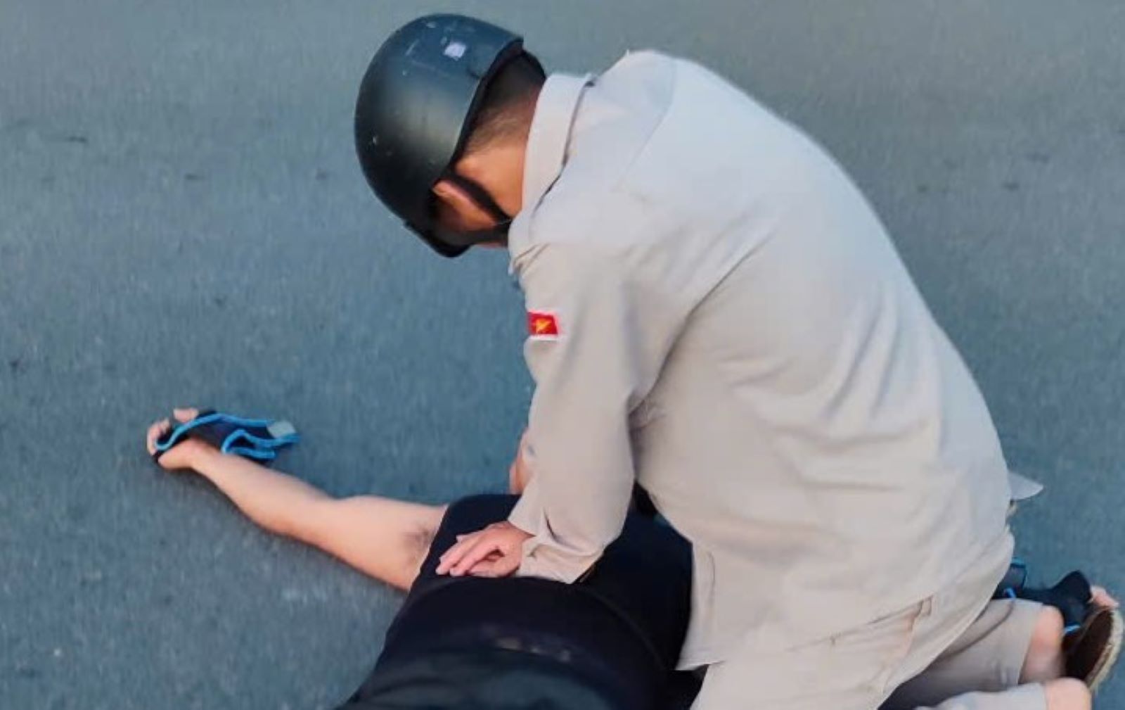 Los peatones apoyaron los primeros auxilios al hombre de la bicicleta sospechoso de un derrame cerebral. Foto: Quang Tri