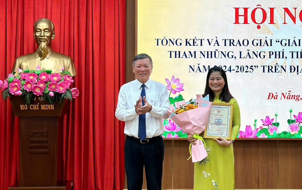 Chairman of the Vietnam Fatherland Front Committee of Da Nang City Le Van Trung presented the Special Prize Certificate to author Truong Thi Diep (Da Nang City Political School). Photo: Van Sum