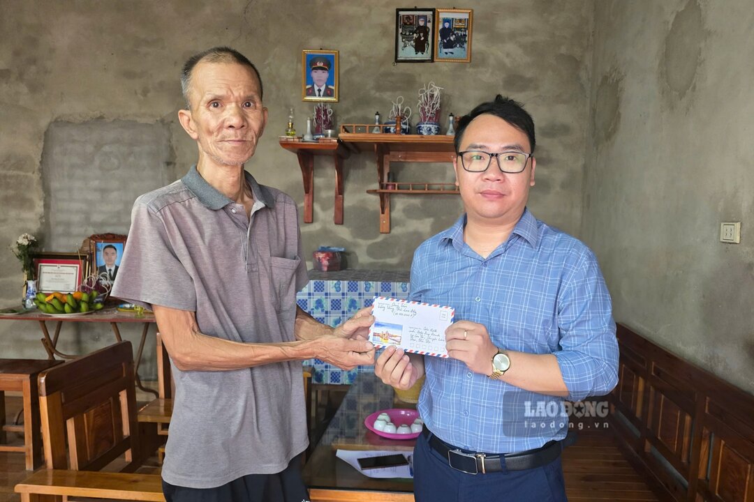 Dai dien Quy XHTT Tam long Vang - Bao Lao Dong trao so tien ung ho cua ban doc tan tay ong Phong. Anh: To Cong.