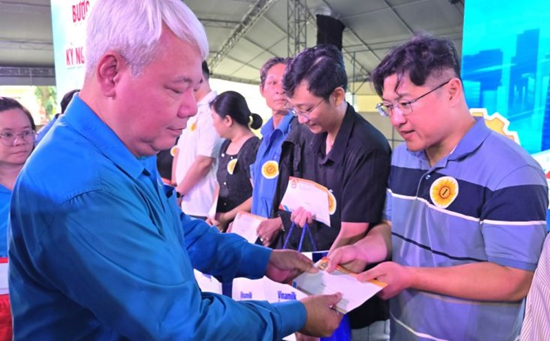 Mr. Vo Khac Thai - Chairman of the Ho Chi Minh City Labor Federation (left cover) - presented gifts to workers on the occasion of the 17th Workers' Month in 2025. Photo: Nam Duong