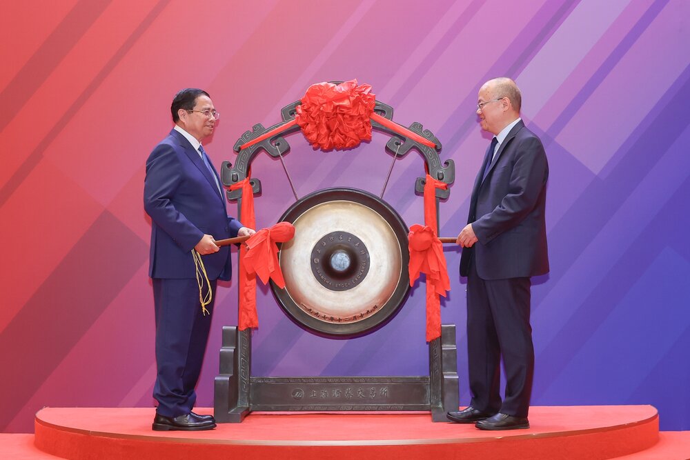 Miembro de Politburo, el primer ministro Pham Minh Chinh, realizo el ritual de interpretar el gong que abrio la sesion en la Bolsa de Valores de Shanghai (SSE). Foto: VGP