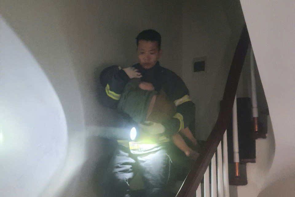 Las fuerzas de rescate sacaron a un niño en un incendio de la casa de manera segura. Foto: Policia de Hanoi