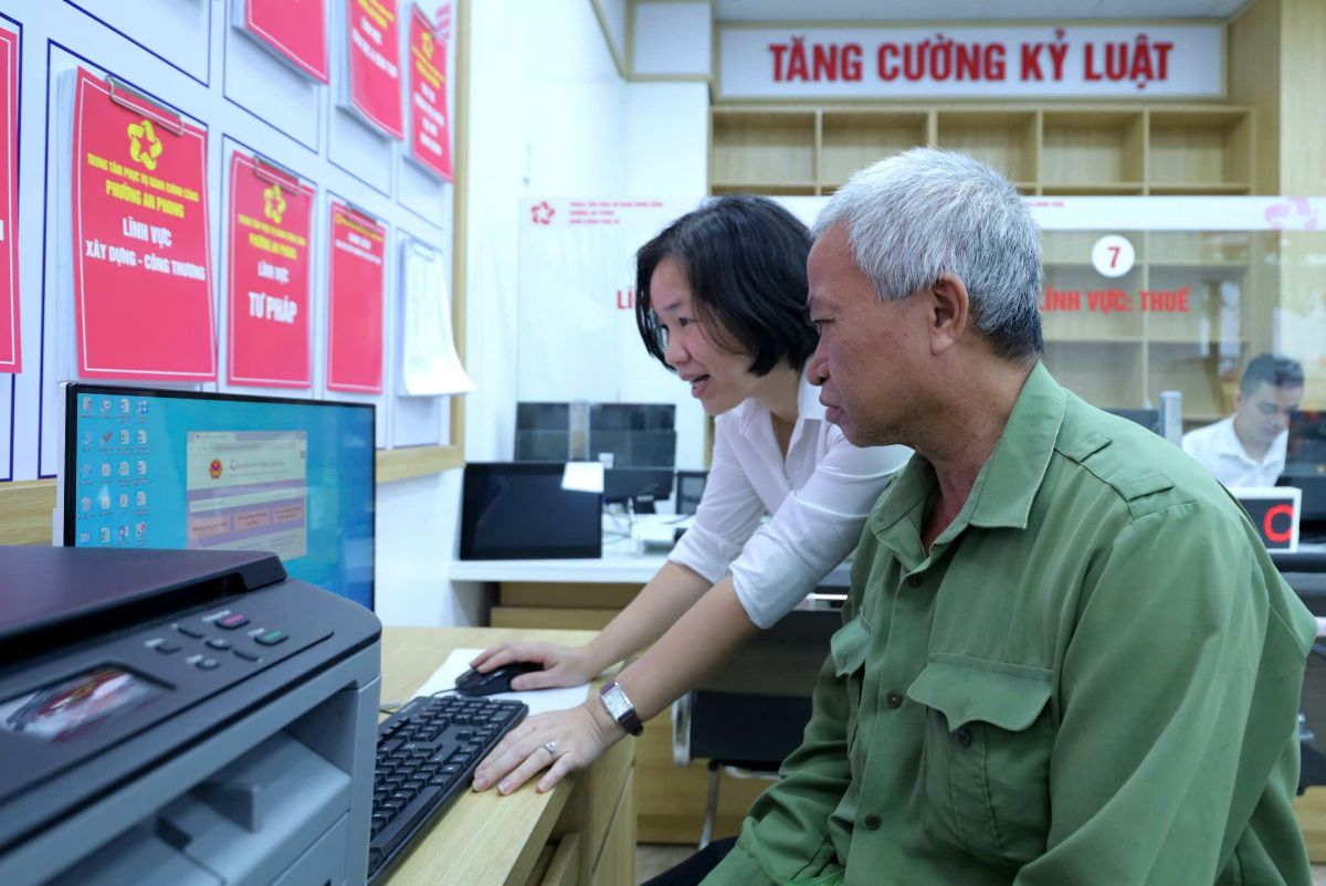 Nguoi dan duoc ho tro dang ki ho so tren Cong dich vu cong. Ảnh: Anh Tuan