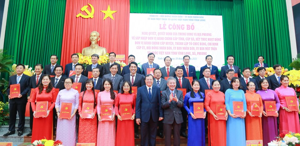 The Executive Committee of the Vinh Long Provincial Party Committee presented the decision to 124 Secretaries of communes and wards in the province after the merger. Photo: Hoang Loc