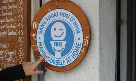 Tấm biển màu xanh có dòng chữ “Free Restroom” thông báo địa điểm đặt nhà vệ sinh miễn phí tại Hà Nội. Ảnh: Lê Tuyến