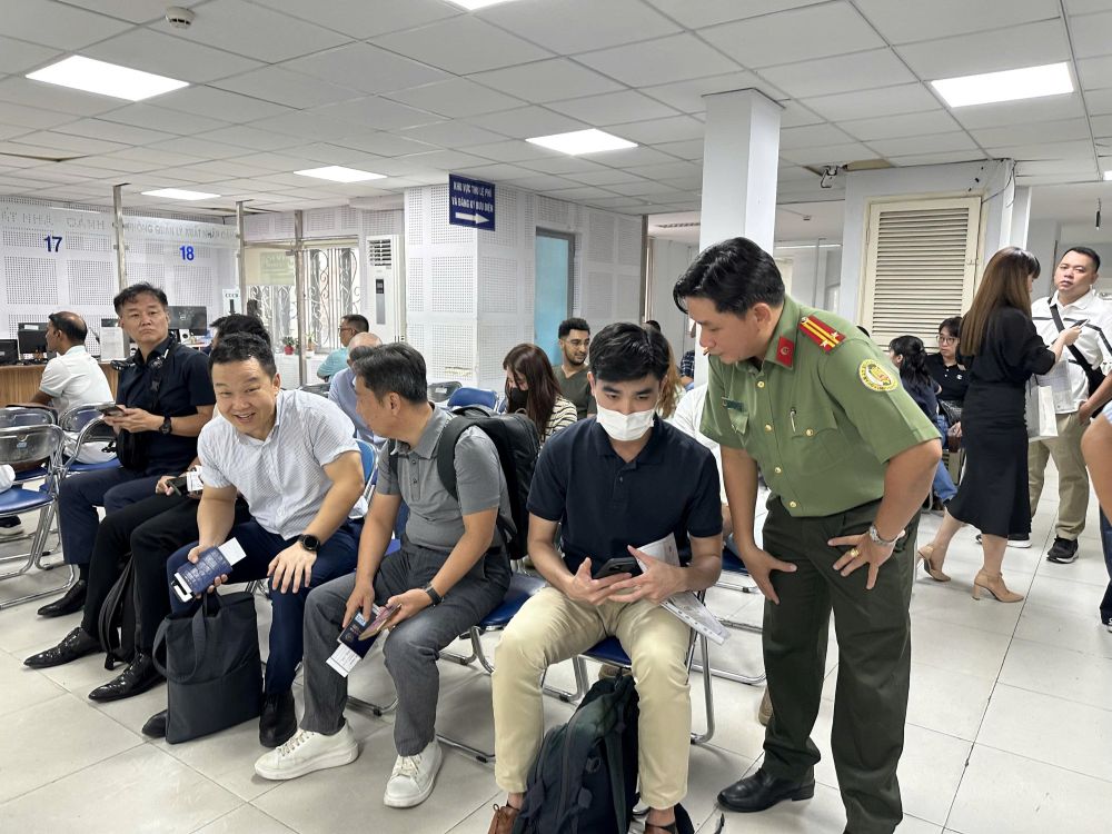Can bo den huong dan truc tiep ho tro nguoi nuoc ngoai lam VNEID. Anh: Anh Tu