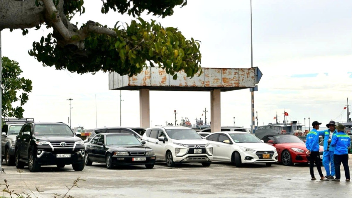 Vehicles are parked in the wharf, waiting to board the ferry on the afternoon of July 19. Photo: Thanh An