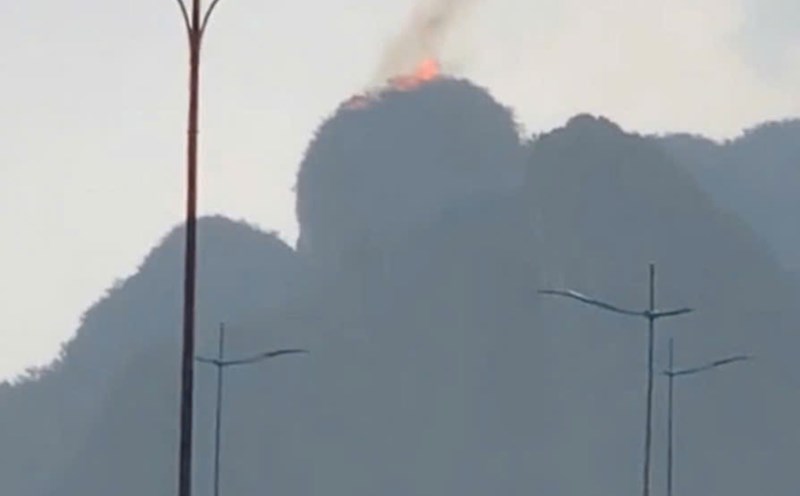 Set fire on the top of the mountain on the shore of Ha Long Bay. Photo cut from video clip