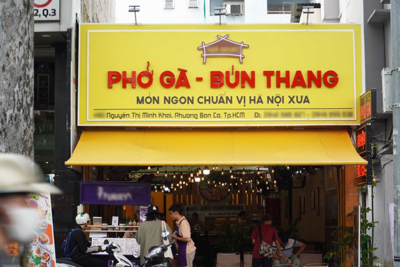 Un restaurant de la rue Nguyen Thi Minh Khai met a jour le nouveau quartier sur le panneau. Photo : Ngoc Le