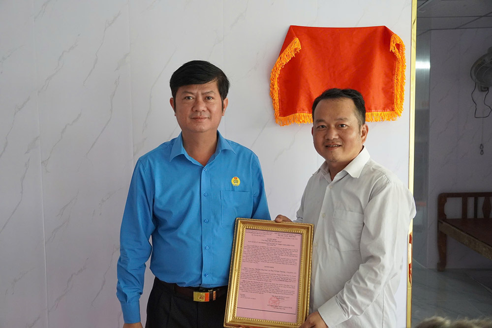 베트남 조국전선 위원회 부위원장이자 Tay Ninh 지방 노동 연맹 위원장인 Tran Le Duy 씨(왼쪽)가 Vo Ngoc Thuong 씨에게 315 노동조합의 따뜻한 보금자리를 수여하는 결정을 수여하고 있습니다. 사진: Tay Ninh 지방 노동 연맹