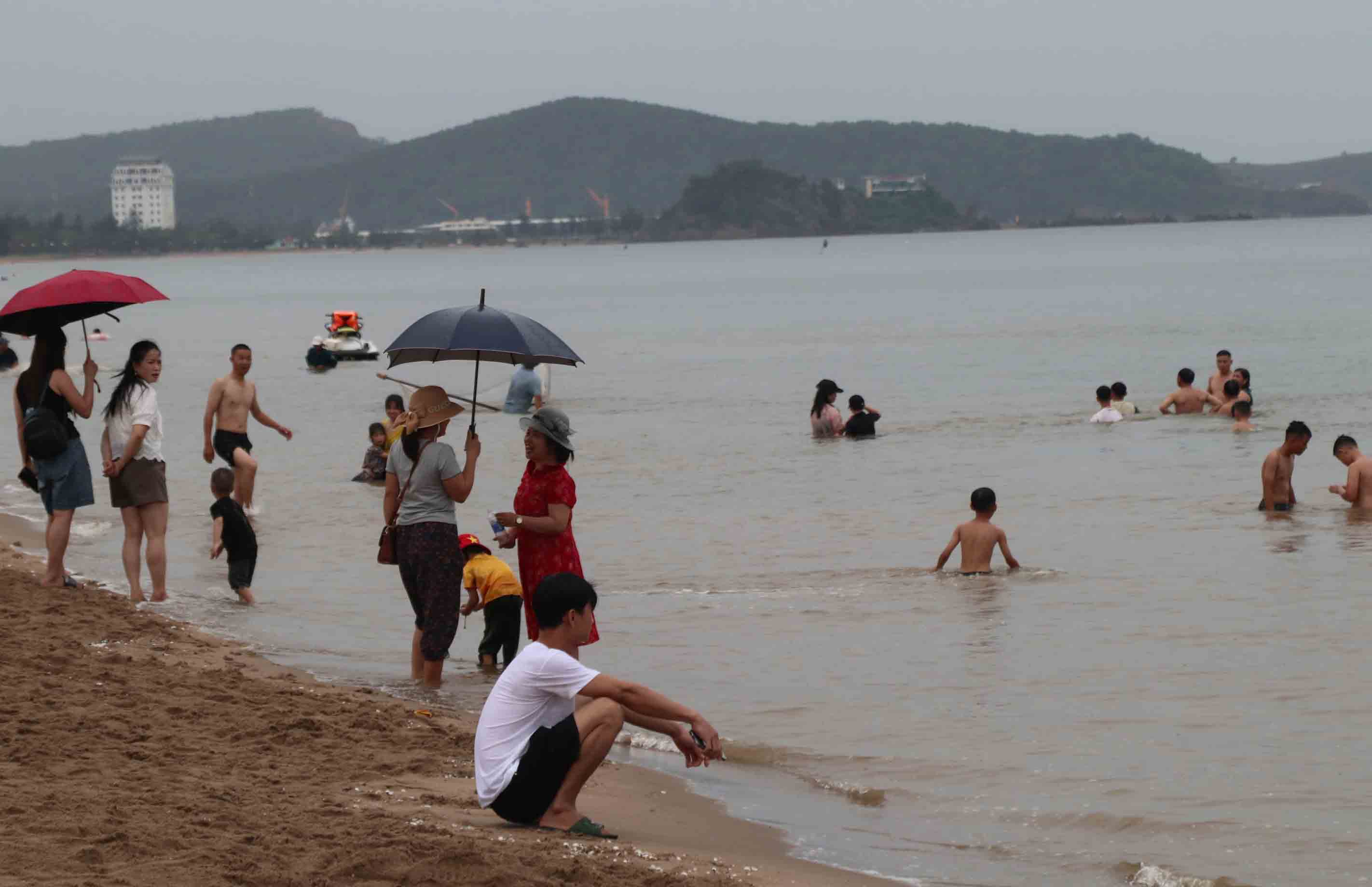 7月21日にCua Loの海水浴を冒険する多くの人々。写真:Duy Chuong