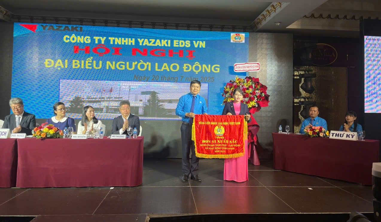Ông Nguyễn Tấn Đạt - Phó Chủ tịch LĐLĐ TPHCM - trao cờ thi đua của Tổng LĐLĐ Việt Nam cho Ban chấp hành CĐCS Công ty TNHH Yazaki EDS VN. Ảnh: Dương Bình