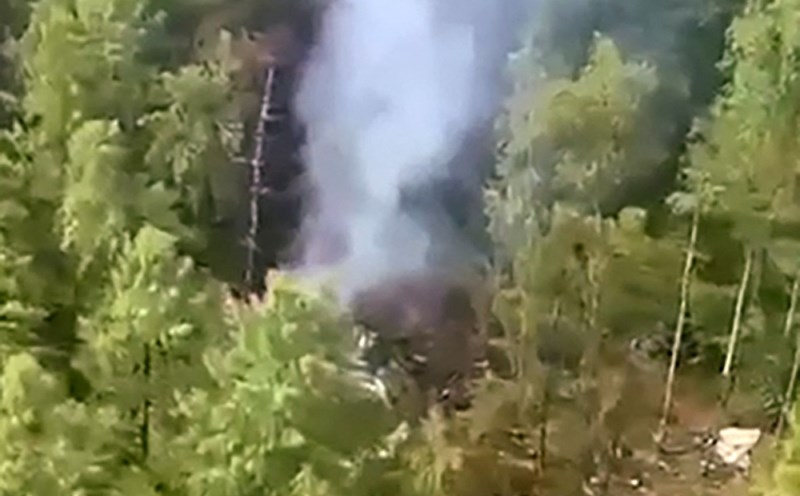 Smoke rises from the scene of the crash of the Russian An-24 plane, July 24, 2025. Photo: AFP