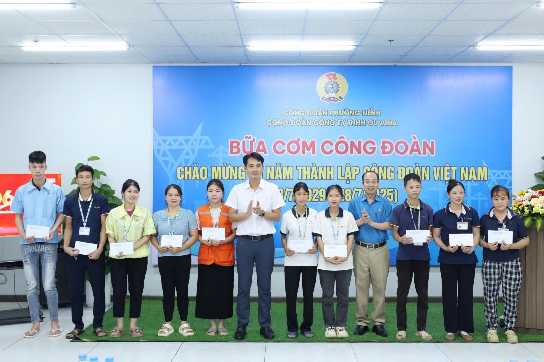 Ong Le Duc Tho - Pho Chu tich Lien doan Lao dong tinh Bac Ninh (thu 4 tu phai qua) trao qua toi cong nhan lao dong. Anh: Quyet Chien