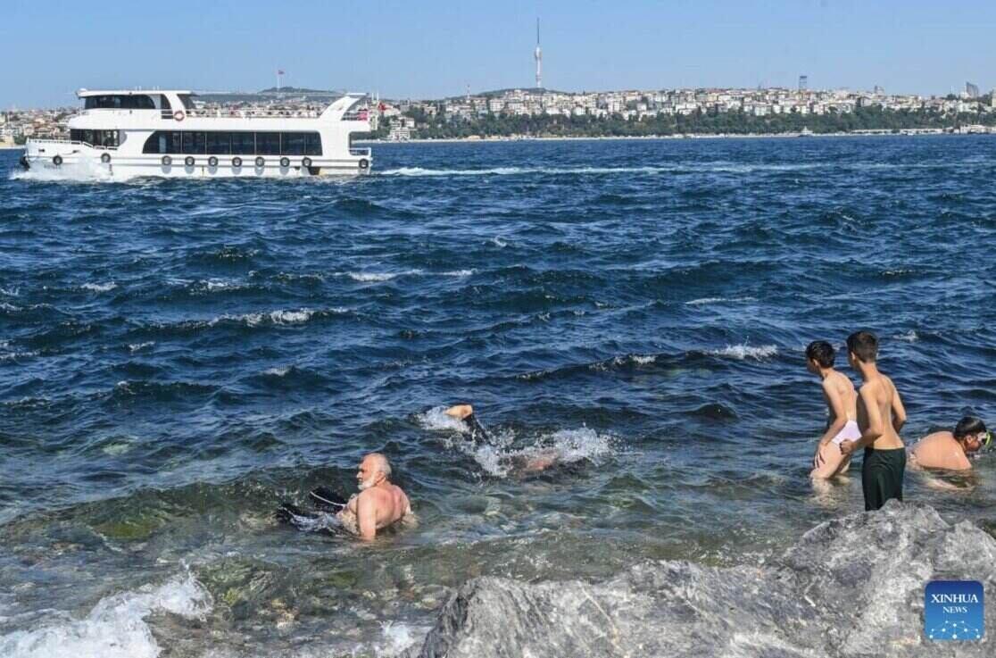 터키 이스탄불의 뜨거운 햇볕 아래 마르마라 해변에서 수영하는 관광객. 사진: 신화통신