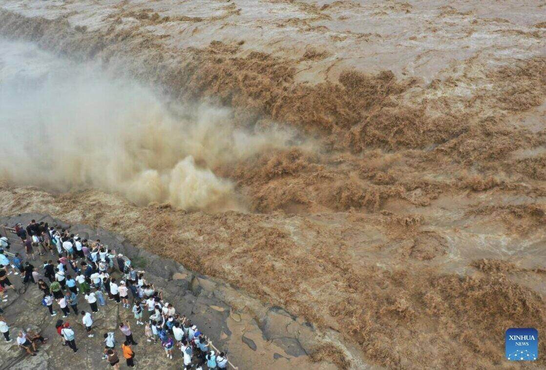 Tourists visit Ho Khau waterfall on the Hoang Ha river in Son Tay province, northern China on July 27. Ho Khau Waterfall is recording a gradual increase in water flow in recent days. Photo: Xinhua