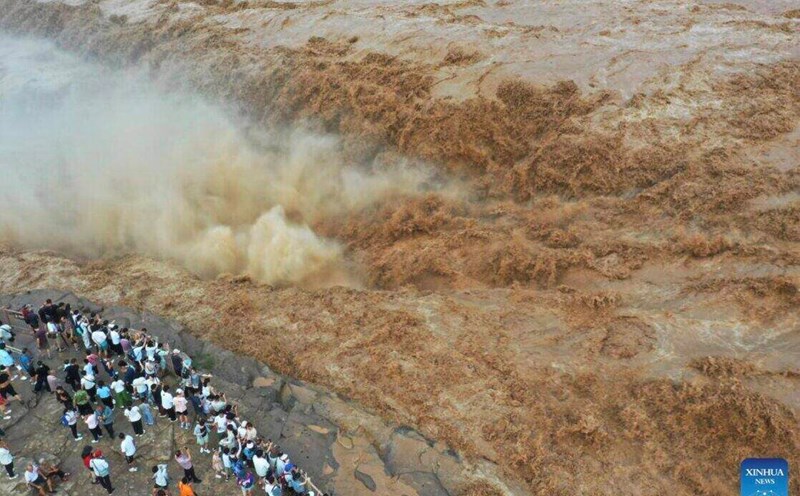 Tourists visit Ho Khau waterfall on the Hoang Ha river in Son Tay province, northern China on July 27. Ho Khau Waterfall is recording a gradual increase in water flow in recent days. Photo: Xinhua