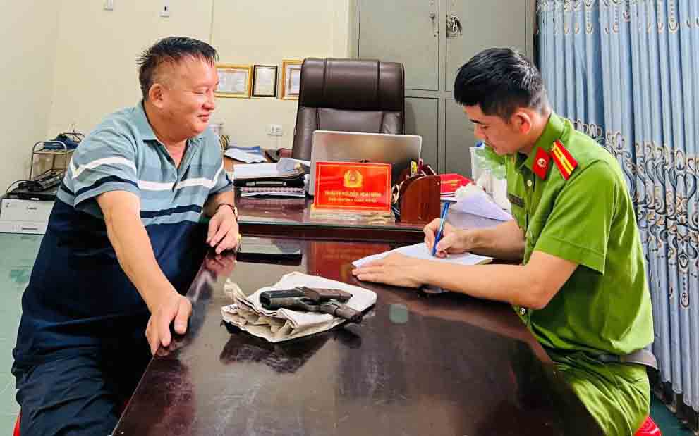 M. Hoang remet la arme a feu a la police de la commune de Huong Khe. Photo : Police de Ha Tinh.