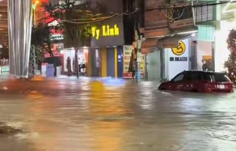 La pluie de la nuit du 2 juillet a inonde les rues et les vehicules ont ete immerges dans l'eau. Photo : Ngoc Duyen