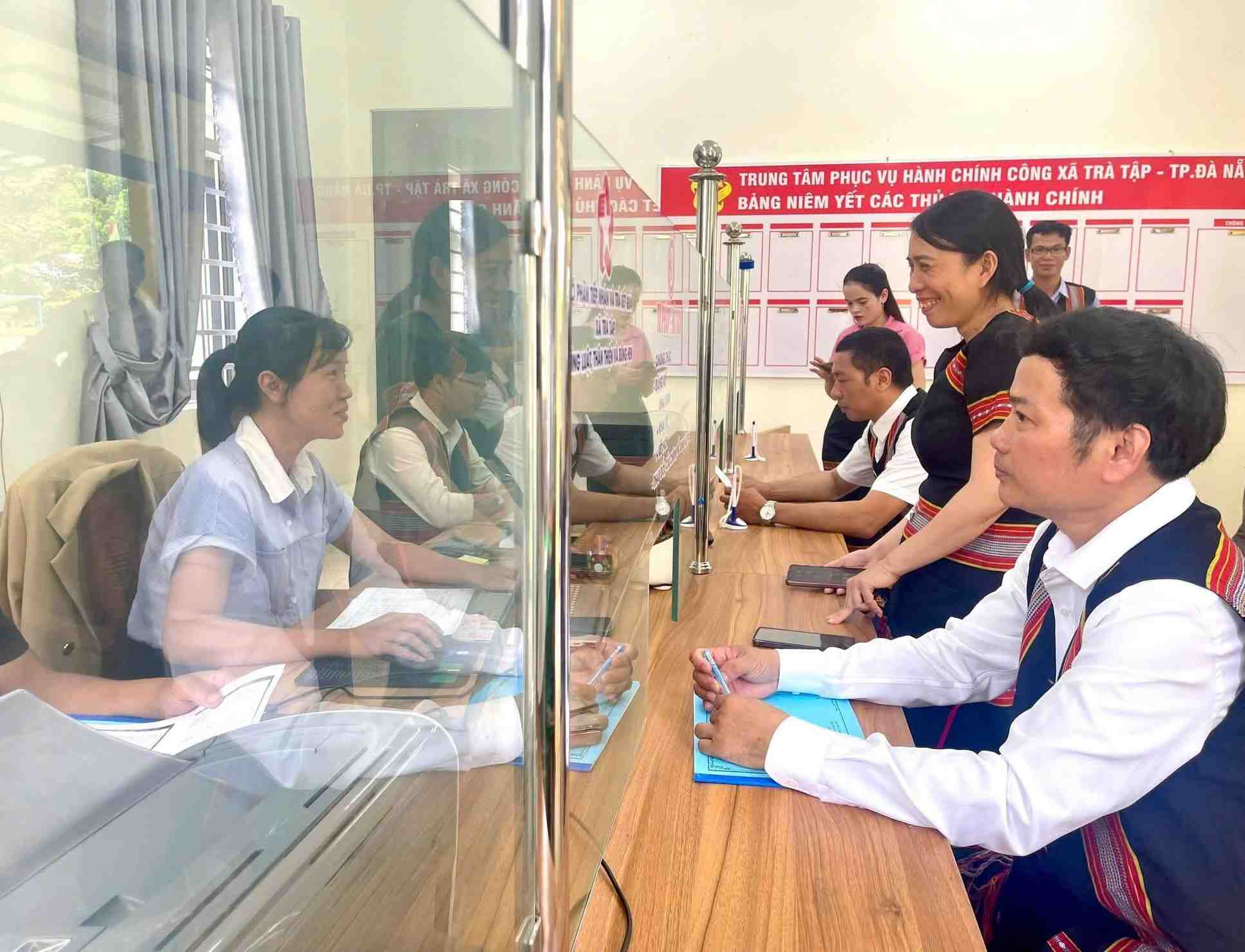 다낭 산악 지역 공무원들이 시민들에게 스마트폰으로 온라인으로 행정 절차를 처리하도록 안내하고 있습니다. 사진: 쯔엉 안