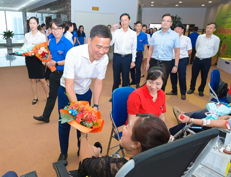 Sr. Vu Anh Tuan - Vicepresidente del sindicato de Petrovietnam, dando flores, alentando a funcionarios y trabajadores a participar en la donacion de sangre. Foto: Minh Duc
