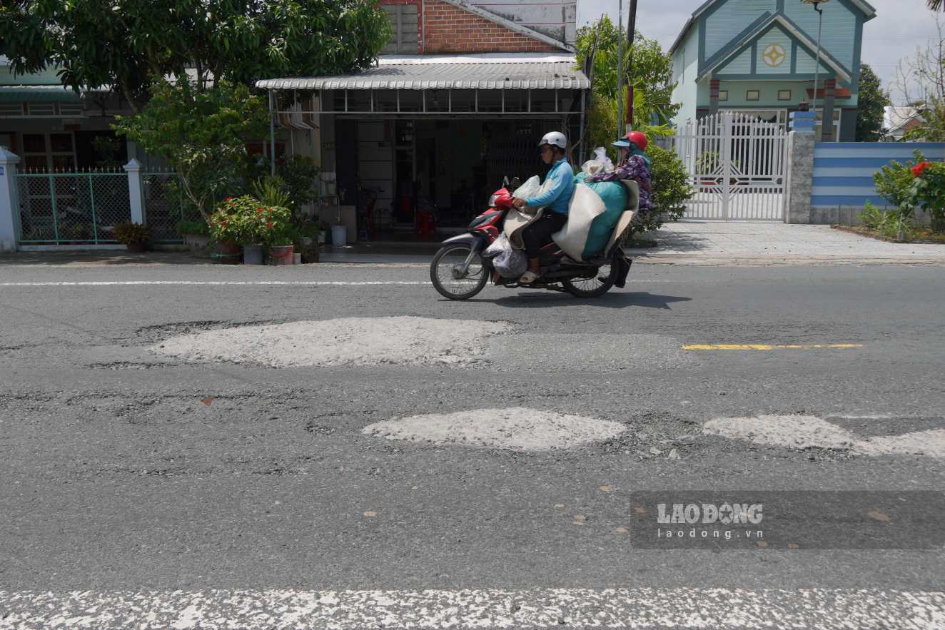 Close-up of National Highway 80 in An Giang full of patches