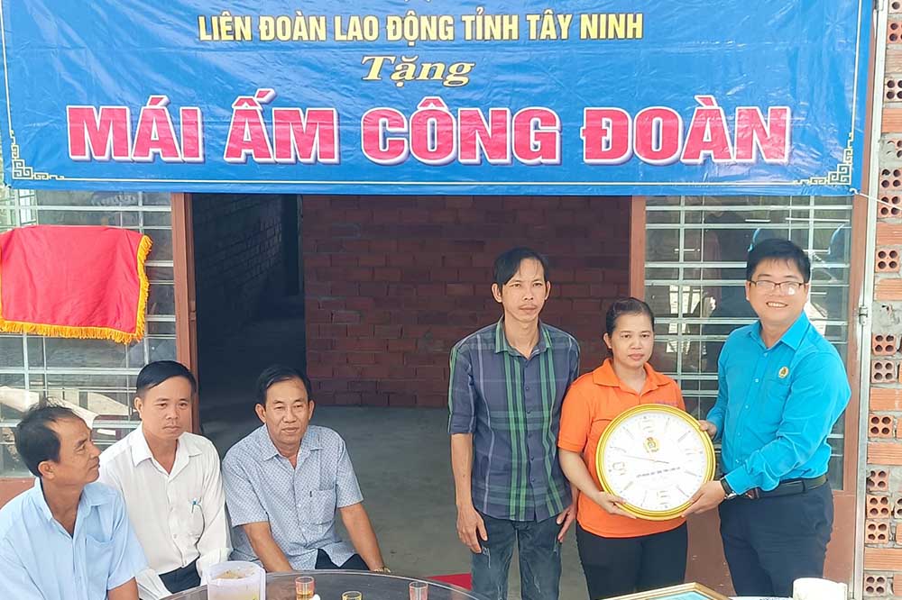 Tay Ninh 지방 노동 연맹 부위원장 Nguyen Hoai Thanh이 노동 조합원에게 Vladimir 노동 조합의 집을 수여하고 있습니다. 사진: My Hanh