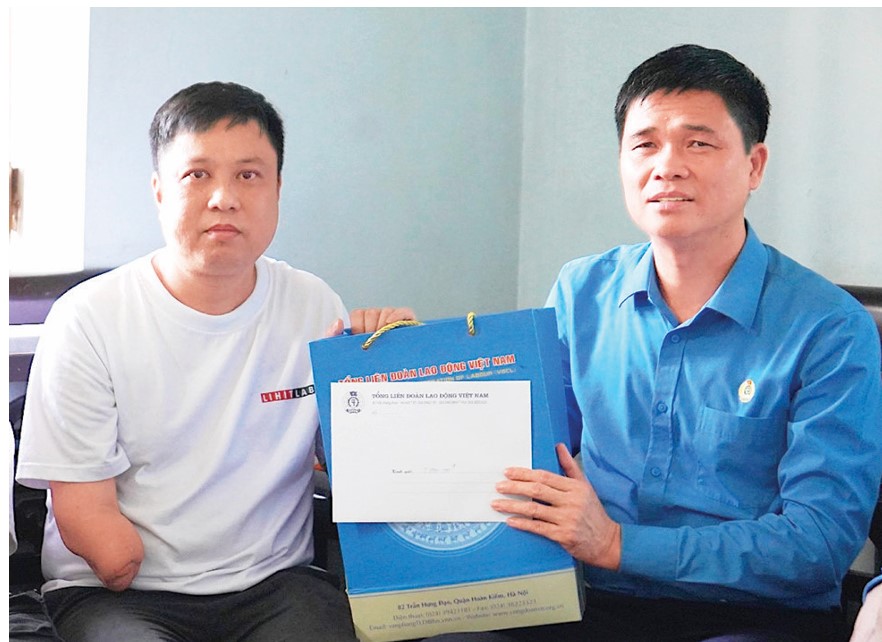 2025년 노동자의 달을 맞아 응오주이히에우 베트남 노동총연맹 부위원장이 하이퐁에서 산업재해를 입은 노동자들에게 선물을 전달하고 있습니다. 사진: MAI DUNG