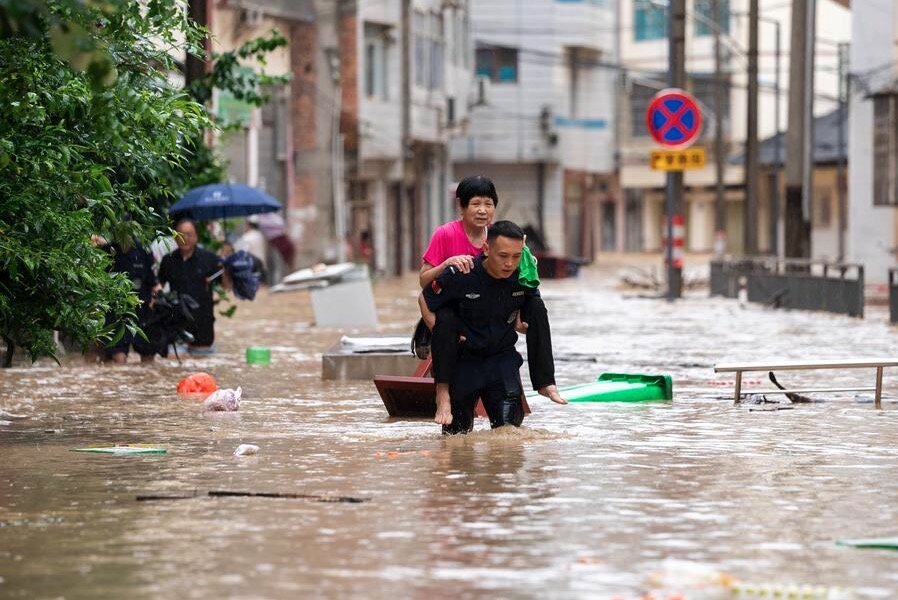 A rescue worker helps evacuate an elderly person from a flooded area in Tungjiang district, Guizhou province, southwestern China, on June 24, 2025. Photo: Xinhua
