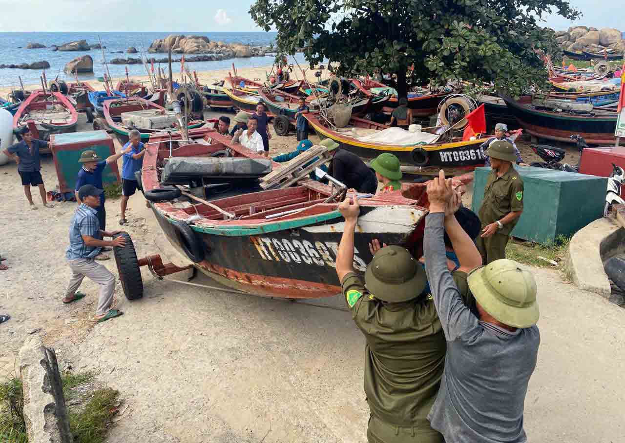 Police and militia support Ha Tinh fishermen to lift their boats to higher ground to avoid storm No. 5. Photo: Ha Tinh Police.