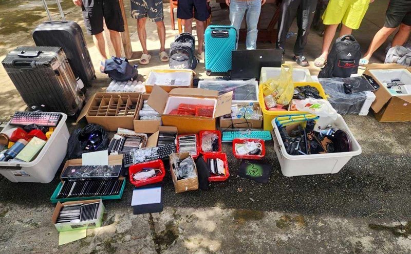 Suspects with phones and equipment were seized during a search of an online fraud center in Stung Treng province, Cambodia, on July 18, 2025. Photo: AFP