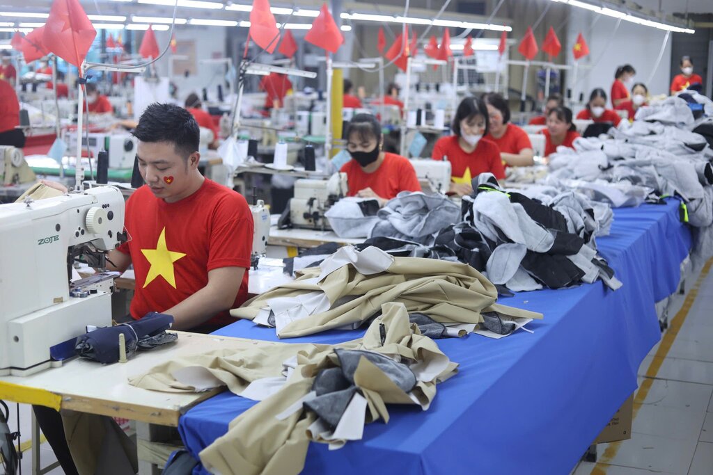 하이퐁 노동자들이 민족적 자부심을 확산시키기 위해 빈 생산 공장에서 일제히 붉은 깃발 셔츠를 입고 있습니다. 사진: SHINTS BVT 회사