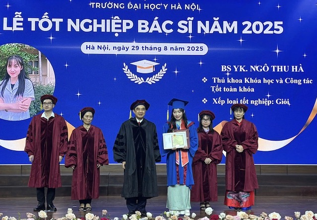 Professor Nguyen Huu Tu - Principal of Hanoi Medical University awarded the graduation certificate to valedictorian Ngo Thu Ha. Photo: Thanh Huyen