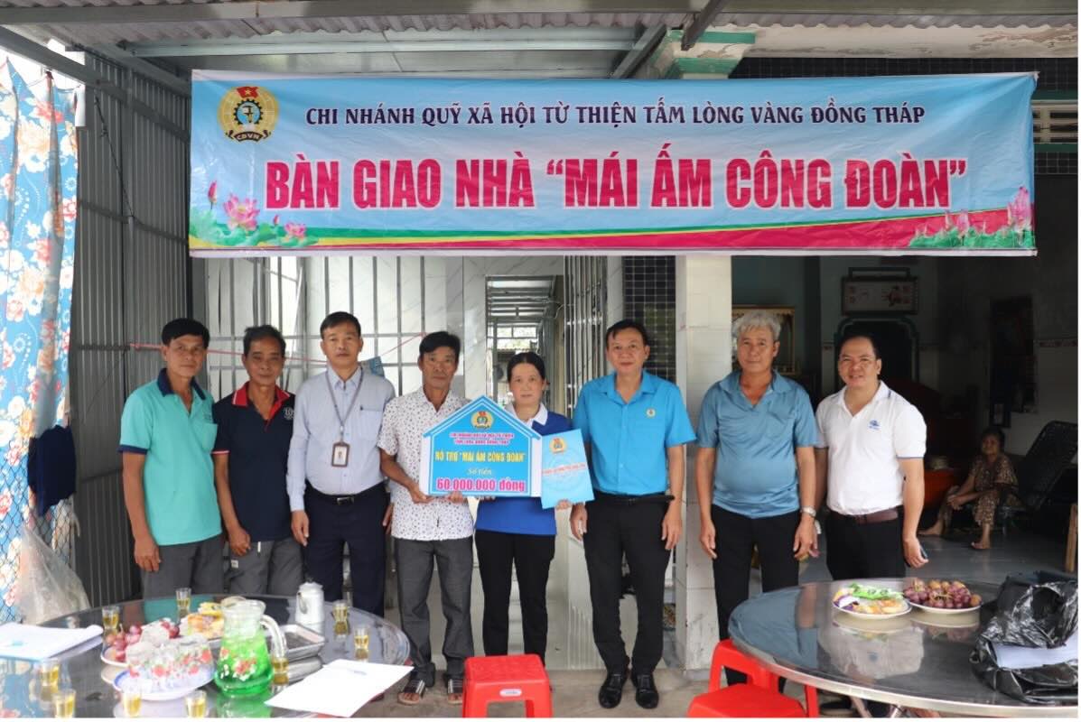 Dai dien LDLD tinh, CDCS Cong ty TNHH MTV Thanh Binh Dong Thap chup anh luu niem cung gia dinh doan vien Vo Thi Rieng. Anh: Luu Hung.