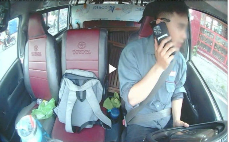 Image of a driver of a transport business car using a mobile phone while driving was detected through a journey monitoring device. Photo: Police