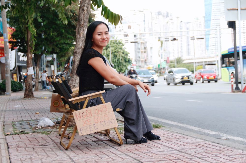 Chi Nguyen Thi Ngoc Anh (36 tuoi, que Dak Lak) da dat hai chiec ghe mien phi cho moi nguoi ngoi cho xe buyt. Anh: Thai Bao