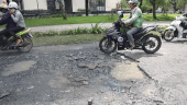 Close-up of a series of potholes on the road repaired and then damaged in the East of Ho Chi Minh City