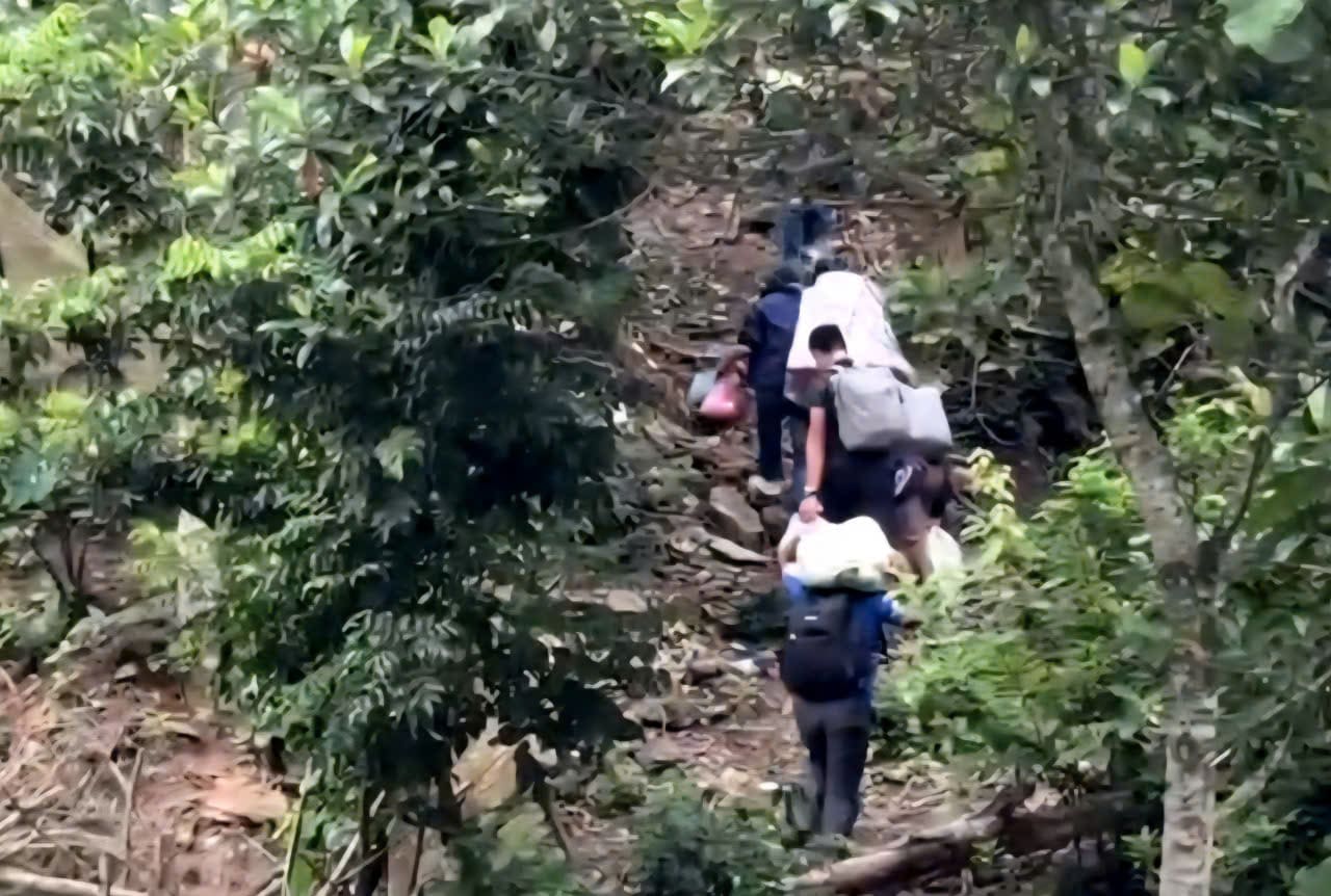 De mang duoc thuc pham vao truong, cac thay co phai vac bo di qua rung. Anh: Nguyen Truong