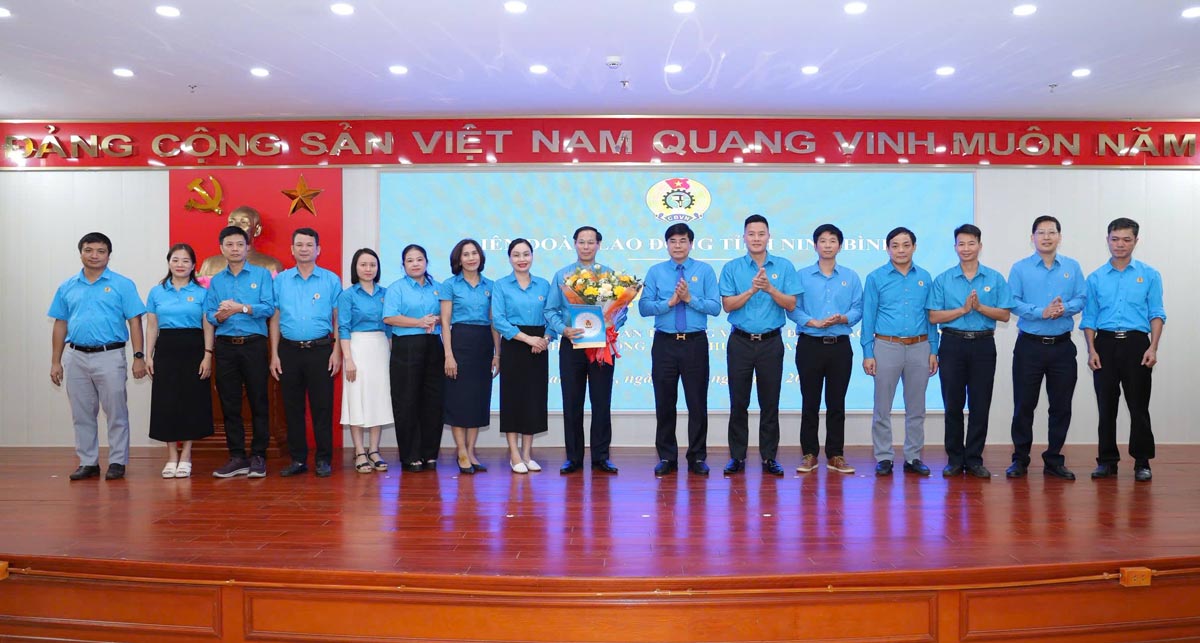 Les dirigeants de la Federation du travail de la province de Ninh Binh remettent la decision et offrent des fleurs au Comite executif du syndicat du quartier de Nam Dinh. Photo : Syndicat de Ninh Binh