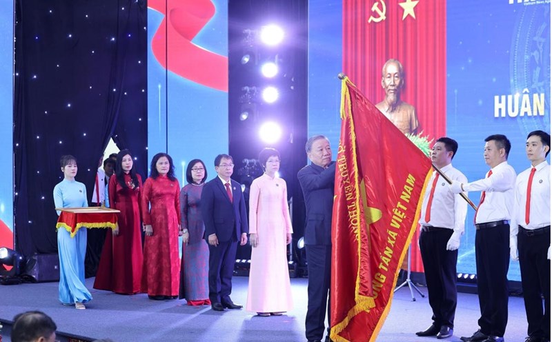 General Secretary To Lam attaches the Ho Chi Minh Medal to the traditional flag of Vietnam News Agency. Photo: Lam Khanh/VNA
